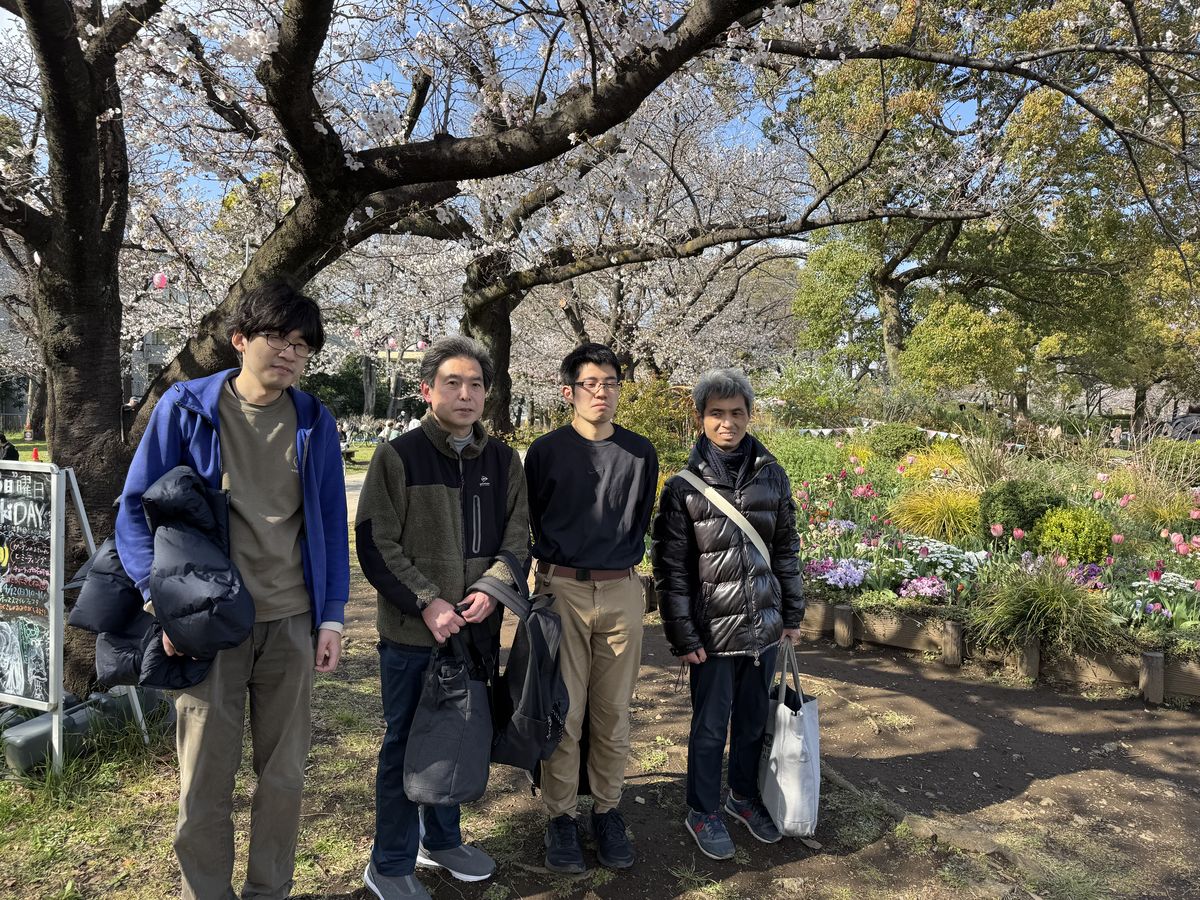 桜と花壇の前で